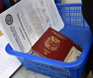 View of Venezuelan migrants documents at an Interpol facility in Lima on August 29, 2018. Peru allowed the entry of hundreds of Venezuelan citizens as cooperation agreements between Colombia and Peru are drawn to filter migrants with criminal records, and health authorities at the Ecuador-Peru border evaluate how to deal with vast numbers of migrants not bearing health records. / AFP PHOTO / CRIS BOURONCLE