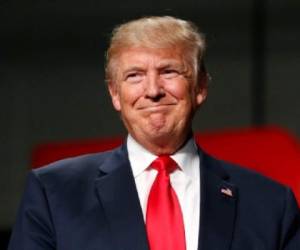 (FILES) This file photo taken on October 31, 2016 shows US Republican Presidential nominee Donald Trump addresses supporters at Macomb Community College in Warren, Michigan.President-elect Donald Trump's threats to retaliate against US companies planning to shift operations overseas constitute a new risk for multinationals, but may not sway those already planning to offshore jobs. Trump laid down the gauntlet on December 1 at a campaign-style rally after striking a deal with Carrier to keep about 1,100 jobs in Indiana in exchange for $7 million in state tax incentives over 10 years. / AFP PHOTO / JEFF KOWALSKY