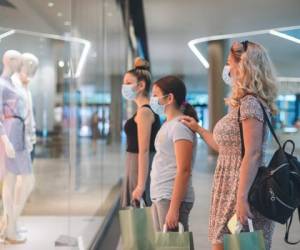 Family shopping at the mall during COVID-19 pandemic. They wears a protective mask to protect from coronavirus COVID-19.