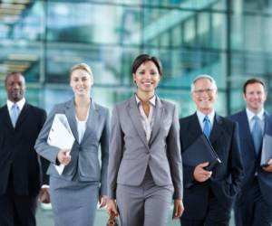 Portrait of beautiful female executive walking with her dedicated team