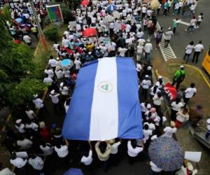 Supporters of Nicaraguan President Daniel Ortega march demanding justice for the 'Victims of Terrorism' and jail for those guilty of violent acts during the recent protests, in Managua on July 21, 2018.The chances of talks finding a solution to Nicaragua's unrest are almost nil after Ortega used force to crush protests and called Catholic bishops mediating the talks 'coup-mongers,' analysts and rights groups said Friday. Ortega, a 72-year-old former guerrilla seen as increasingly autocratic, has taken a hardline stance in three months of street demonstrations demanding his departure. / AFP PHOTO / Inti OCON