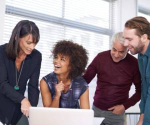 Cropped shot of a group of architects using a laptop to work on their designs