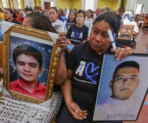 Members of the organization Mothers of April (AMA) hold portraits of their late loved ones during a mass 'for Freedom, Justice and Memory' at the Cathedral in Managua on February 23, 2020. - The AMA is an organization of mothers of youngsters killed during the April 2018 opposition protests. (Photo by INTI OCON / AFP)