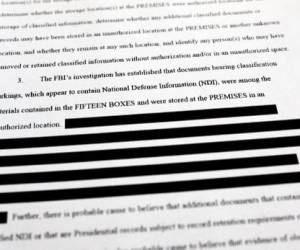 CALIFORNIA - AUGUST 27: In this photo illustration, a page is viewed from the government’s released version of the F.B.I. search warrant affidavit for former President Donald Trump’s Mar-a-Lago estate on August 27, 2022 in California. The 32-page affidavit was heavily redacted for the protection of witnesses and law enforcement and to ensure the ‘integrity of the ongoing investigation’. (Photo Illustration by Mario Tama/Getty Images)MARIO TAMA / GETTY IMAGES NORTH AMERICA / Getty Images via AFP