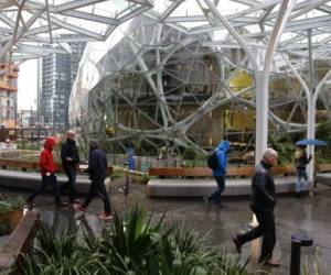 People take a tour during the grand opening of the Amazon Spheres, in Seattle, Washington on January 29, 2018.  - Amazon opened its new Seattle office space which looks more like a rainforest. The company created the Spheres Complex to help spark employee creativity. (Photo by JASON REDMOND / AFP)