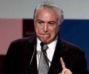 Brazil's President Michel Temer gestures as he delivers a speech, during the Global Child Forum on South America inauguration ceremony, at Sao Paulo's Industry Federation (FIESP) building, in Sao Paulo, Brazil on April 04, 2017. / AFP PHOTO / Miguel SCHINCARIOL