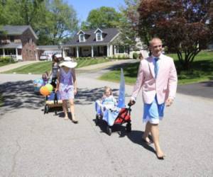 LOUISVILLE, KY - MAY 2: Jesse Cronin leads his family on a parade in the neighborhood on May 2, 2020 in Louisville, Kentucky. With the Kentucky Derby and its festival of activities postponed until September due to the COVID-19 pandemic the family had their own celebration. Saturday would of been the running of the 146th Kentucky Derby. Andy Lyons/Getty Images/AFP