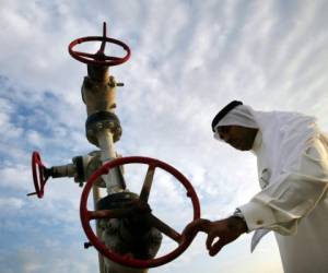 MANAMA, BAHRAIN - NOVEMBER 3: Khalid Abdulla Alhajeri looks at a natural gas pipe November 3, 2002 in Manama, Bahrain. The country was the first in the Arab side of the Gulf to discover oil. The country is the home port for the United States Navy's 5th Fleet, the battle group that patrols the Gulf. The kingdom is a crucial link in any war with Iraq. The Navy has had a base there since 1948. (Photo by Joe Raedle/Getty Images)