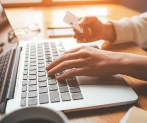 A young woman makes an online payment for a purchase. Online shopping.