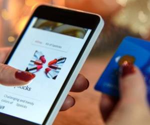 Modern Woman makes Christmas shopping via smartphone and a credit card in the e-store