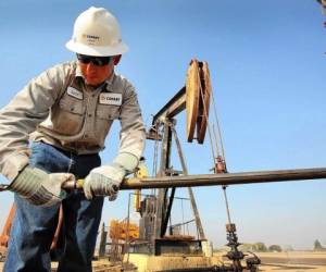 (FILES) In this file photo taken on March 12, 2019 a pump jack operates at an oil extraction site in Cotulla, Texas. - US crude crashed to below $15 a barrel on April 20, 2020, its lowest level for over two decades, as concerns about a virus-triggered demand shock and lack of storage eclipsed an output cut deal. (Photo by Loren ELLIOTT / AFP)