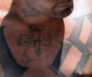 View of the tattoos of an alleged member of the 18 gang as he is presented to the press in San Salvador on February 26, 2016. Members of the national civil police and the armed forces captured 240 dangerous gang members accused of homicide and extortion in the last three days in different areas of El Salvador, informed Friday the public prosecutor's office. El Salvador faces an escalation of violence attributed mostly to the war between the MS-13 and 18 ST gangs. AFP PHOTO / Marvin RECINOS / AFP PHOTO / Marvin RECINOS