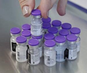 Vials of the Pfizer vaccine against the COVID-19 coronavirus are displayed as medical workers get vaccinated at Sourasky Medical Center (Ichilov) in the Israeli coastal city of Tel Aviv, on December 20, 2020. - Israel has ordered 14 million doses of the vaccine -- covering seven million people, as two doses are required per person for optimal protection -- from Pfizer as well as US biotech firm Moderna. The vaccine will be rolled out at 10 hospitals and vaccination centres around Israel for healthcare workers from Sunday, according to the health ministry. (Photo by JACK GUEZ / AFP)