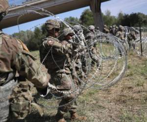 HIDALGO, TX - NOVEMBER 02: U.S. Army soldiers from Ft. Riley, Kansas install protective wire along the Rio Grande at the U.S.-Mexico border on November 2, 2018 in Hidalgo, Texas. U.S. President Donald Trump ordered the troops to the border to bolster security at points of entry where an immigrant caravan may attempt to cross in upcoming weeks. The troops in Hidalgo were from the 97th MP Battalion and had arrived to the Rio Grande Valley the day before. John Moore/Getty Images/AFP