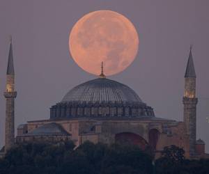 The Sturgeon super moon rises over the Ayasofya-i Kebir Camii or Hagia Sophia Grand Mosque in Istanbul on August 2, 2023. (Photo by YASIN AKGUL / AFP)