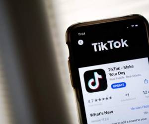 A man walks past a German ad for Chinese video-sharing social networking service Tiktok in Berlin on September 23, 2020. (Photo by John MACDOUGALL / AFP)