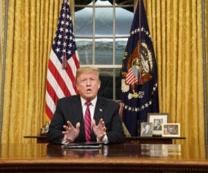 US President Donald Trump delivers an address to the nation on funding for a border wall from the Oval Office of the White House in Washington DC on January 8, 2019. (Photo by CARLOS BARRIA / POOL / AFP)
