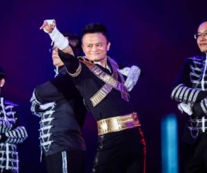 This photo taken on September 8, 2017 shows Jack Ma, chairman of Alibaba group, dancing to a medley of Michael Jackson songs during the Alibaba Annual Party at the Huanglong sports center in Hangzhou in China's eastern Zhejiang province. Ma danced with other Alibaba employees during the party, which was held to celebrate the 18th anniversary of the company's founding. / AFP PHOTO / STR / China OUT