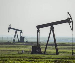 Pump jacks operate in an oil field in the countryside of al-Qahtaniyah town in Syria's northeastern Hasakeh province near the Turkish border, on March 11, 2020. (Photo by Delil SOULEIMAN / AFP)