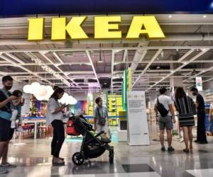 People queue up to enter IKEA as it reopened after restrictions to halt the spread of the COVID-19 coronavirus were lifted in Bangkok on May 17, 2020. (Photo by Lillian SUWANRUMPHA / AFP)