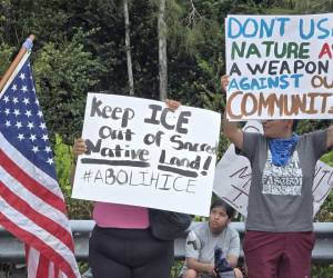 <i>Personas sostienen carteles durante una protesta junto al nuevo centro de detención para migrantes, conocido como 'Alligator Alcatraz' este martes, en Ochopee (Estados Unidos). Cerca de un centenar de personas protestaron contra la construcción del centro de detención 'Alligator Alcatraz' durante la visita del presidente estadounidense, Donald Trump. EFE/ Alberto Boal</i>
