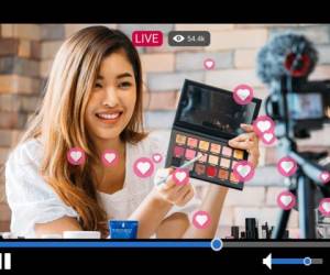 Young beautiful woman recording live stream video for makeup and cosmetics business purpose online with video player interface and full of positive feedbacks