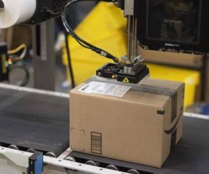 A package is labeled at a SLAM, or scan, label, apply and manifest during a tour of Amazon's Fulfillment Center, September 21, 2018 in Kent, Washington. / AFP PHOTO / Grant HINDSLEY