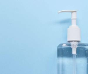 Bottle of a hand sanitizer against blue background