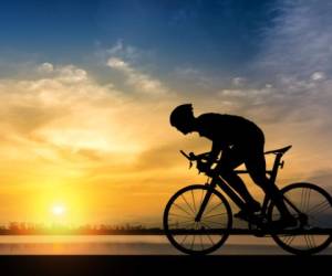 Silhouette of cyclist on the background of beautiful sunset,Silhouette of man ride a bicycle in sunset background.