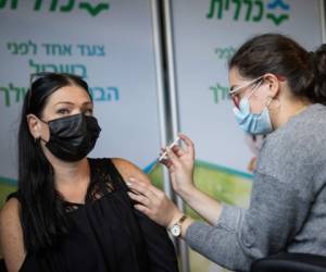 Worker from the education field receives a Covid-19 vaccine injection, at Clalit Covid-19 vaccination center in Jerusalem, on January 12, 2021. Photo by Yonatan Sindel/Flash90