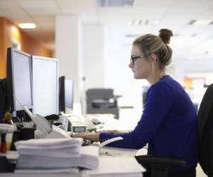 Young woman using computer in office