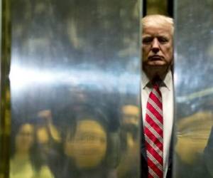 US President-elect Donald Trump boards the elevator after escorting Martin Luther King III to the lobby after meetings at Trump Tower in New York City on January 16, 2017. / AFP PHOTO / DOMINICK REUTER