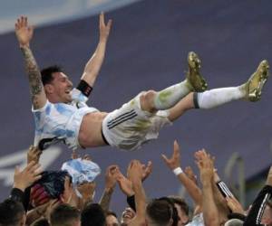 Argentina's Lionel Messi is thrown into the air by teammates after winning the Conmebol 2021 Copa America football tournament final match against Brazil at Maracana Stadium in Rio de Janeiro, Brazil, on July 10, 2021. - Argentina won 1-0. (Photo by CARL DE SOUZA / AFP)
