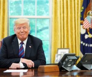 US President Donald Trump listens during a phone conversation with Mexico's President Enrique Pena Nieto on trade in the Oval Office of the White House in Washington, DC on August 27, 2018. President Donald Trump said Monday the US had reached a 'really good deal' with Mexico and talks with Canada would begin shortly on a new regional free trade pact.'It's a big day for trade. It's a really good deal for both countries,' Trump said.'Canada, we will start negotiations shortly. I'll be calling their prime minister very soon,' Trump said.US and Mexican negotiators have been working for weeks to iron out differences in order to revise the nearly 25-year old North American Free Trade Agreement, while Canada was waiting to rejoin the negotiations. / AFP PHOTO / MANDEL NGAN