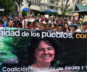 Lenca indigenous people and other activists demonstrate in demand of justice for the crime of Honduran activist Berta Caceres, in the framework of the International Women's Day, outside a criminal court in Tegucigalpa on March 8, 2018. Despite the drastic reduction in the homicide rate reported by the government, murders of women under 23 in Honduras add up 12,371 in the last 20 years, Honduran NGO Casa Alianza reported Thursday. / AFP PHOTO / ORLANDO SIERRA