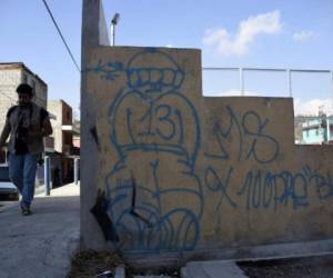 A view of graffiti by the gang Mara Salvatrucha before it was painted over as part of Operation Phoenix, launched to recover territory taken over by gangs in the El Bucaro neighborhood in the municipality of Villa Nueva, 15 km south of Guatemala City, on January 20, 2017. / AFP PHOTO / JOHAN ORDONEZ