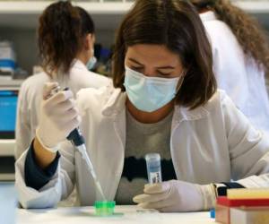 A researcher at the Institute of Molecular Biology and Genetics (IBGM) of the University of Valladolid (UVa) works on searching a vaccine against COVID-19, at a laboratory in Valladolid on November 10, 2020. (Photo by Cesar Manso / AFP)