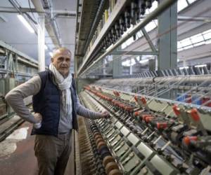 Emmanuel Lang and Velcorex CEO, Pierre Schmitt poses at the manufacturing plant in Hirsingue, eastern France, on November 8, 2021. (Photo by SEBASTIEN BOZON / AFP)