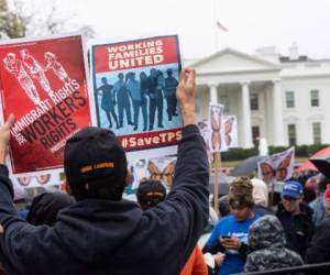 People demonstrate in front of the White House in Washington, DC, on November 9, 2018 against the decision by the administration of US President Donald Trump to terminate Temporary Protected Status (TPS) for people from Sudan, El Salvador, Haiti and Nicaragua. (Photo by NICHOLAS KAMM / AFP)