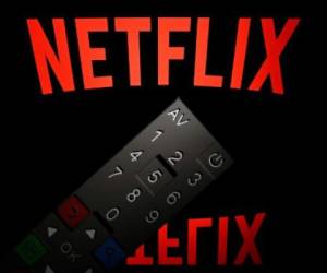 (FILES)This illustration picture taken on April 21, 2018 in Paris shows the logo of the Netflix entertainment company, displayed on a tablet screen with a remote control in front of it. - Netflix unveiled plans January 15, 2019 to boost prices for US subscribers, a move that helped lift shares of the streaming television giant which now faces an array of new competitors.The California-based company, which has nearly half of its 130 million paid members in the US, will raise the price of its most popular streaming plan with high-definition video by 18 percent to $12.99 per month. (Photo by Lionel BONAVENTURE / AFP)