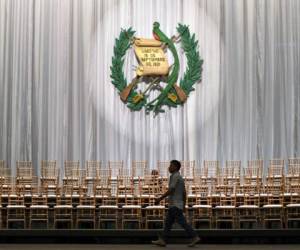 An employee walks past chairs during preparations for Guatemalan President-elect Alejandro Giammattei's swearing-in ceremony at the National Theater, in Guatemala City, on January 13, 2020. - Giammattei will take over on Tuesday as president of Guatemala until 2024 with the challenge of resuming governance to face poverty and corruption, as well as deciding whether to accept Mexicans who are asking for asylum in the United States. (Photo by Orlando ESTRADA / AFP)