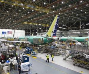(FILES) In this file photograph taken on March 27, 2019, employees work on Boeing 737 MAX aircraft at the Boeing Renton Factory in Renton, Washington State. - The European Union Aviation Safety Agency (EASA) plans to authorise the Boeing 737 MAX to fly again next week, 22 months after the plane was grounded following two fatal crashes. 'For us, the MAX will be able to fly again starting next week,' after publication of a directive clearing the jet, EASA director Patrick Ky said January 19, 2021, in a video conference. (Photo by Jason Redmond / AFP)