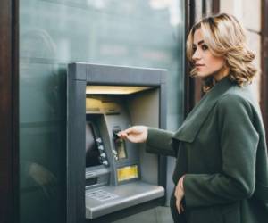 Young woman using a cash machine