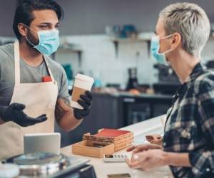 Couple of people with protective masks in cafe