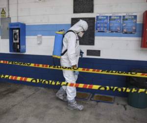 A health worker wearing a protective suit disinfects sports dorms used to house Guatemalan citizens who are deported from the U.S. in Guatemala City on May 14, 2020. (Photo by Johan ORDONEZ / AFP)