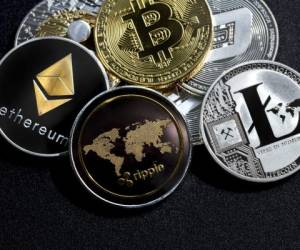 izmir, Turkey - September 28, 2018 Close up ethereum ripple litecoin bitcoin dash coins shot in metallic black background in studio
