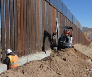 (FILES) In this file photo taken on March 28, 2021, ranch owner Tony Sandoval stands before a portion of the unfinished border wall that former US president Donald Trump tried to build, near the southern Texas border city of Roma. - Texas has begun building its own 'wall' of huge steel bars on the border with Mexico, its Republican Governor Greg Abbott said on December 18, 2021,, accusing President Joe Biden of not doing enough to stop illegal immigration. 'Texas is taking what is really an unprecedented step by any state in the country,' Abbott said, telling a news conference about construction of 'a wall on our border to secure and safeguard the sovereignty of the United States and our own state.' (Photo by Ed JONES / AFP)
