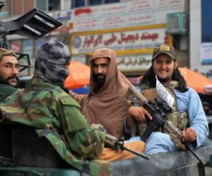 Taliban fighters patrol on a pick-up vehicle along in a street in Kabul on August 31, 2021 after the US pulled all its troops out of the country to end a brutal 20-year war -- one that started and ended with the hardline Islamist in power. (Photo by Hoshang Hashimi / AFP)