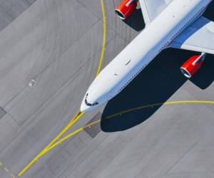 Aerial view of airport. Airplane taxiing to runway before take off.