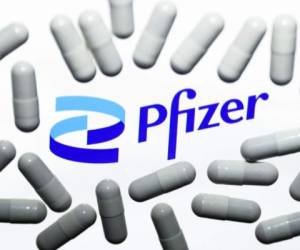 Pfizer logo displayed on a laptop screen and medical pills are seen in this illustration photo taken in Krakow, Poland on October 18, 2021. (Photo by Jakub Porzycki/NurPhoto via Getty Images)